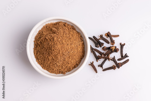 Wallpaper Mural Ground cloves in white ceramic bowl isolated on white background, soft light, studio shot, copy space.Whole cloves. Torontodigital.ca
