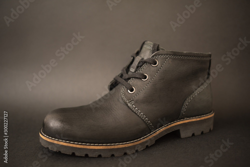 vintage black boots on black background, retro shoes