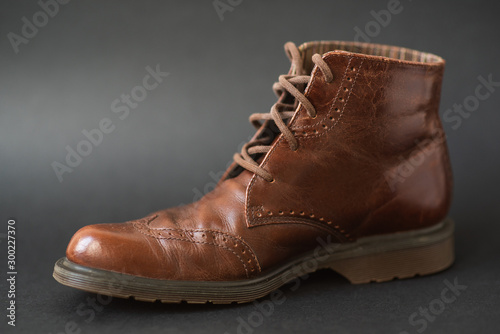 Vintage brown boots on black background, retro shoes