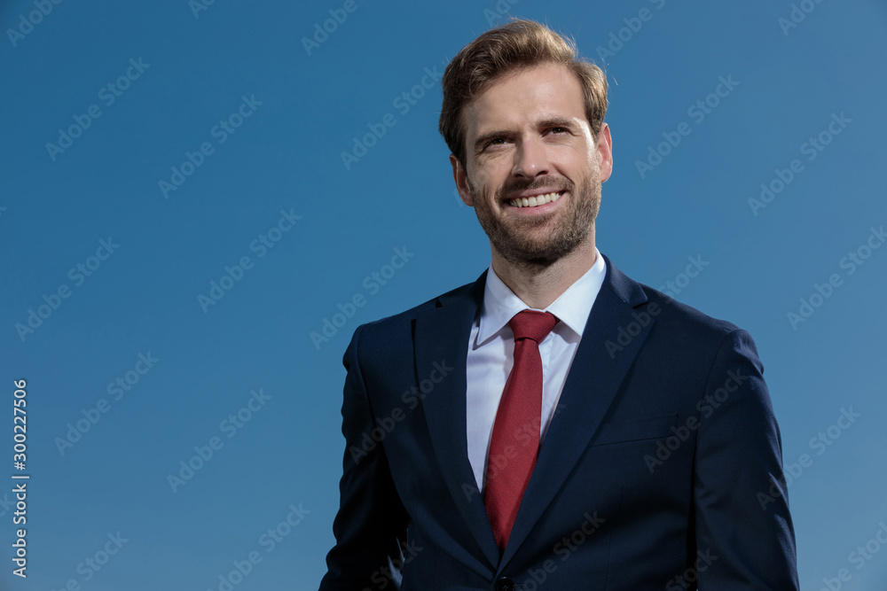Hopeful businessman smiling and looking away Hopeful businessman smiling and looking away