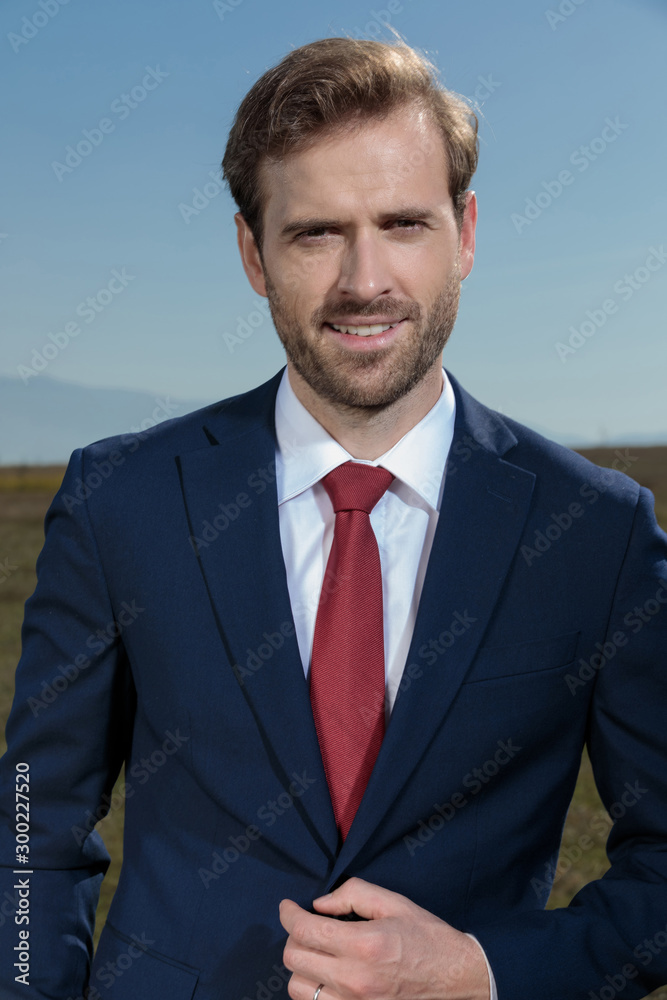 Close up of a confident businessman fixing his jacket Close up of a confident businessman fixing his jacket