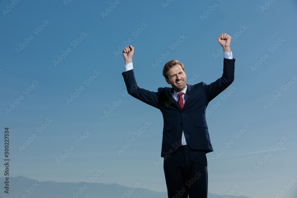 Joyful businessman celebrating and smiling Joyful businessman celebrating and smiling
