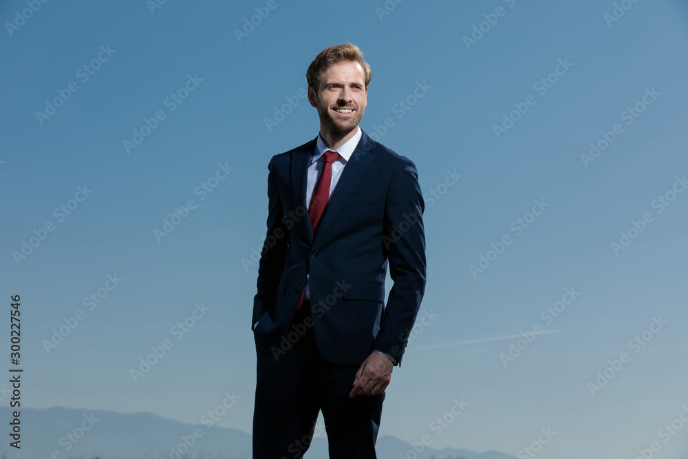 Happy businessman looking away with his hand in his pocket Happy businessman looking away with his hand in his pocket