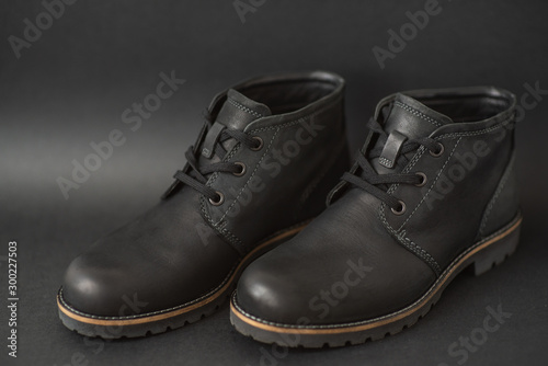 vintage black boots on black background, retro shoes © Pavel