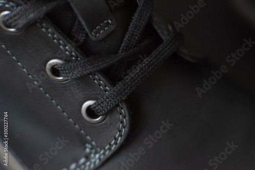 vintage black boots on black background, detail of retro shoes