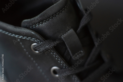 vintage black boots on black background, detail of retro shoes