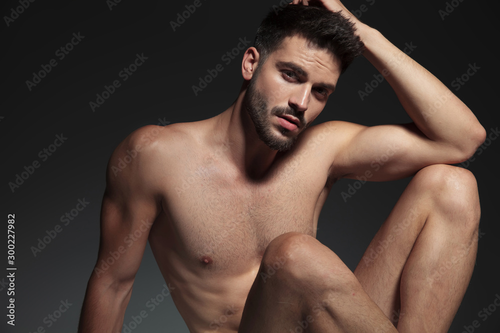 dramatic cool guy holding arm on knee