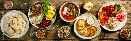 Selection of traditional ukrainian food - borsch, perogies, potato cakes, pickled vegetables, top view