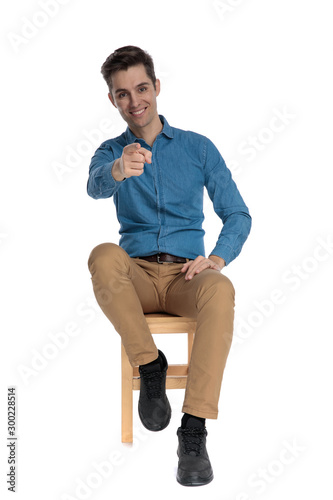 smart casual man smiling and pointing finger