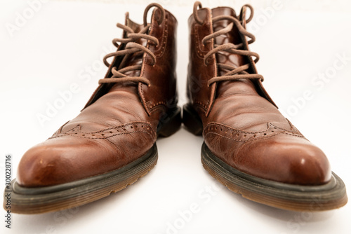 Vintage brown boots on white background, retro shoes