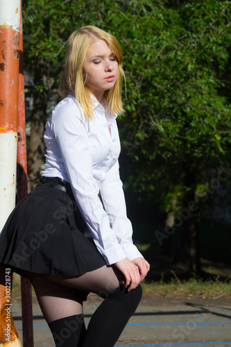 Outdoor portrait of young lady walking on the park.