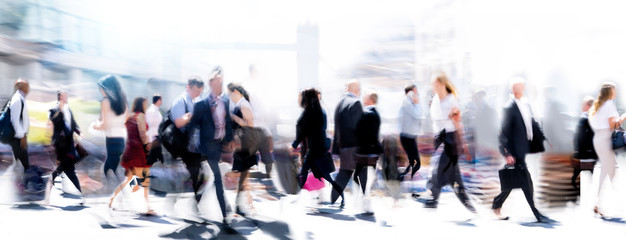 Walking people blur. Lots of people walking in the City of London. Wide panoramic view of people crossing the road. 