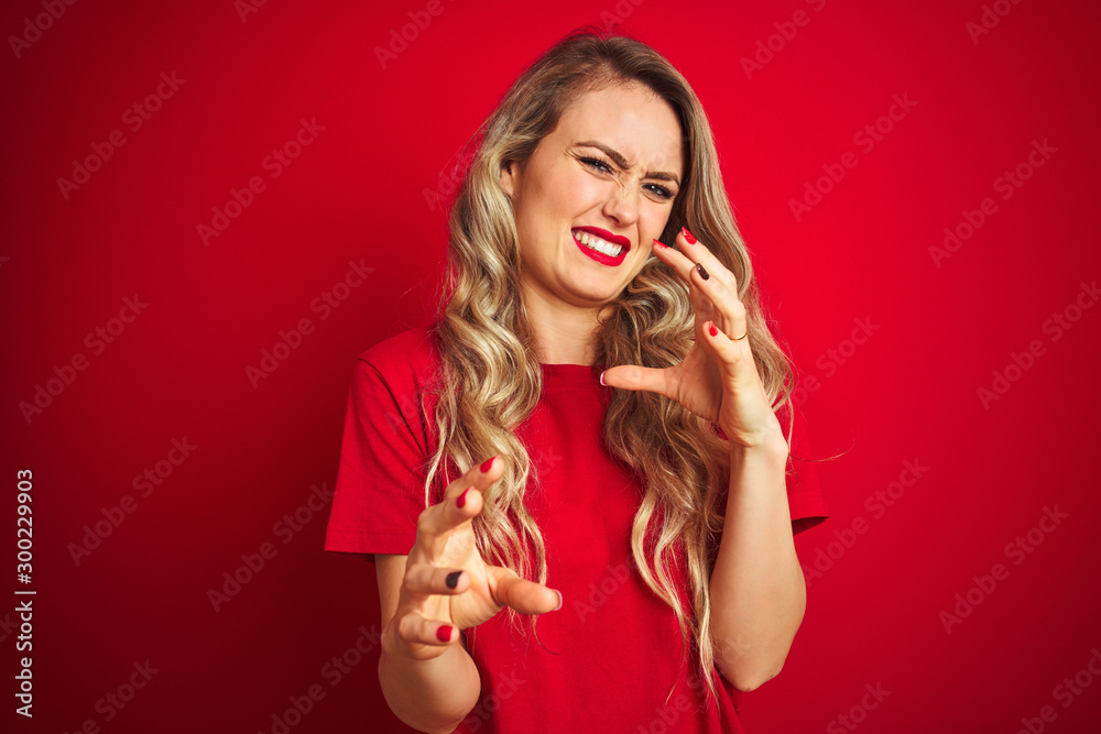 Young beautiful woman wearing basic t-shirt standing over red isolated background disgusted expression, displeased and fearful doing disgust face because aversion reaction. With hands raised. Young beautiful woman wearing basic t-shirt standing over red isolated background disgusted expression, displeased and fearful doing disgust face because aversion reaction. With hands raised.