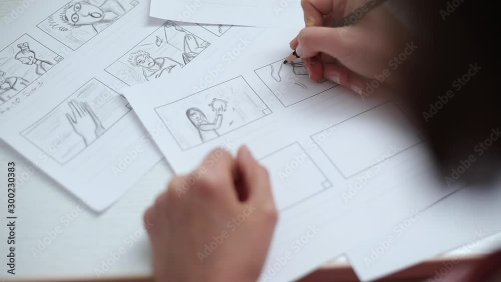 Hands draw with a pencil the storyboard for the film. Hands draw with a pencil the storyboard for the film.