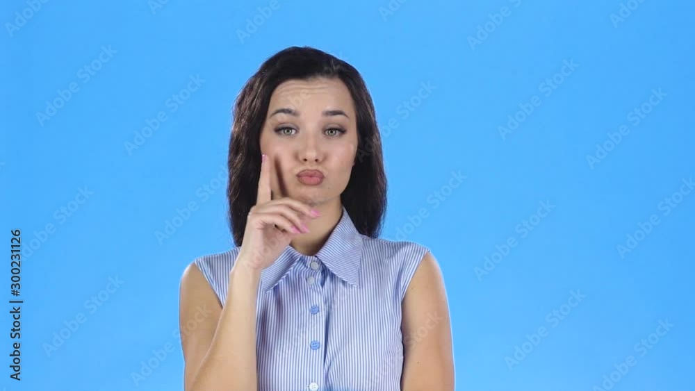 Beautiful woman is thinking and rolling her eyes with happy playful face. Slow motion Beautiful woman is thinking and rolling her eyes with happy playful face. Slow motion