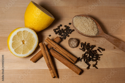 Fototapeta Naklejka Na Ścianę i Meble -  spices for mulled wine and lemon on a wooden board
