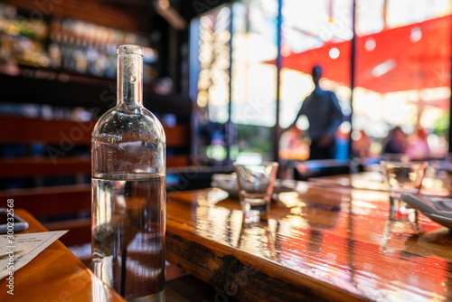 Pitcher of water sitting in shaded moody restaurant in the day