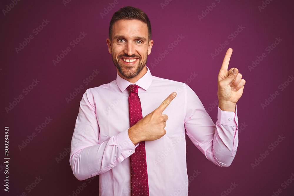 Young business man wearing elegant shirt and tie over purple isolated background smiling and looking at the camera pointing with two hands and fingers to the side. Young business man wearing elegant shirt and tie over purple isolated background smiling and looking at the camera pointing with two hands and fingers to the side.