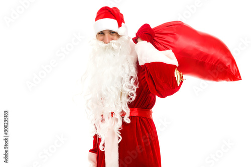 Santa Claus standing up on white background with his bag full of gifts