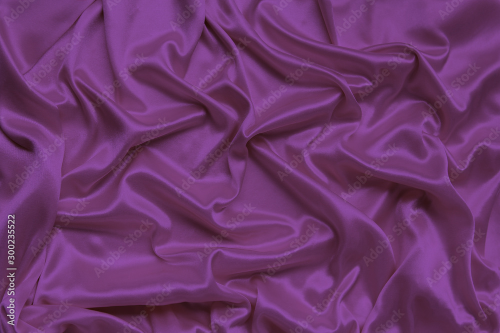 Obraz premium lilac beautiful satin draped with soft folds fabric, silk cloth background, close-up, copy space