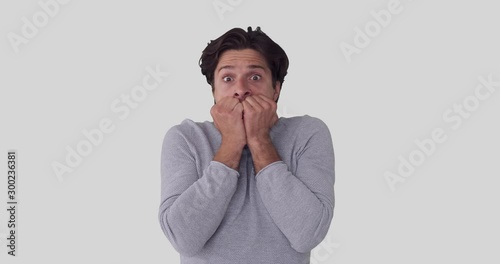 Shocked man feeling nervous and scared over white background