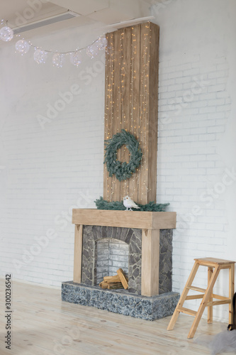white room with fireplace. fireplace in the bedroom with Christmas decoration. wreath over the fireplace