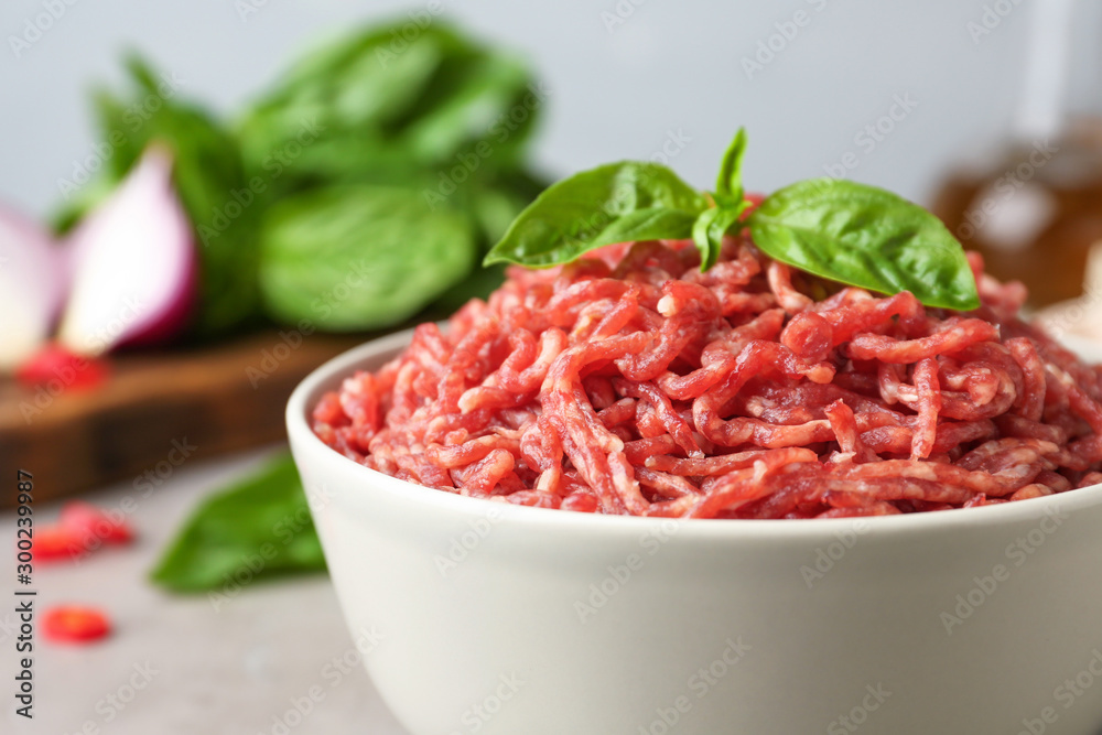 Fresh raw minced meat on light table, closeup Fresh raw minced meat on light table, closeup