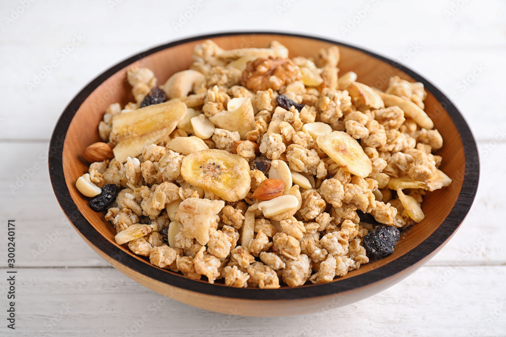 Tasty homemade granola on white wooden table. Healthy breakfast