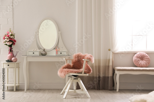 Stylish room interior with white dressing table photo