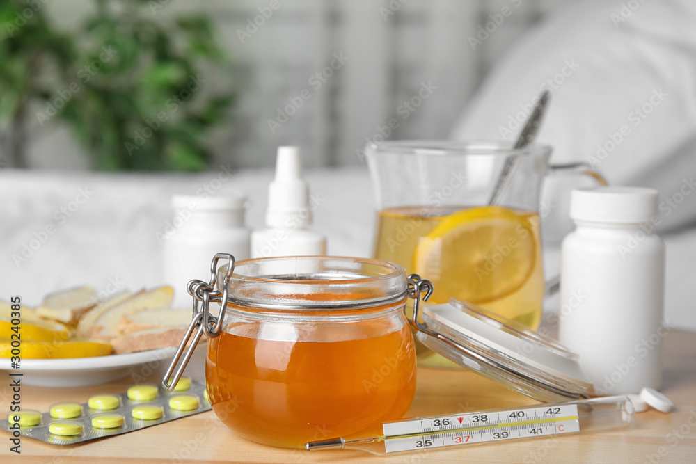 Honey and different cold remedies on wooden table Honey and different cold remedies on wooden table