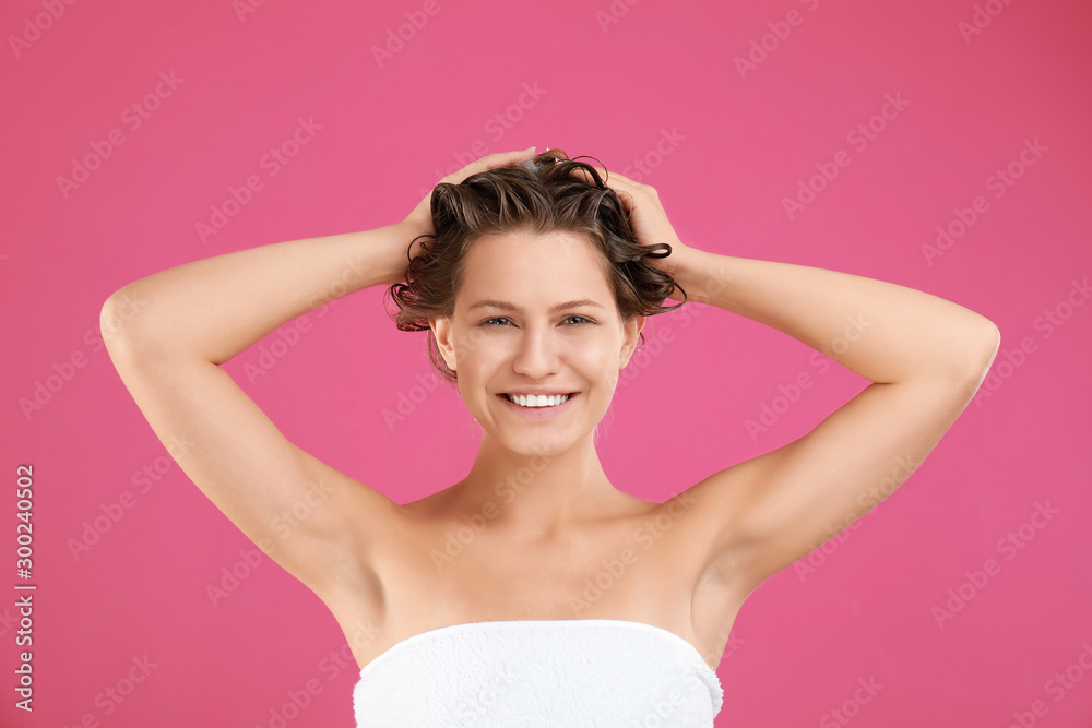 Beautiful young woman washing hair on pink background Beautiful young woman washing hair on pink background