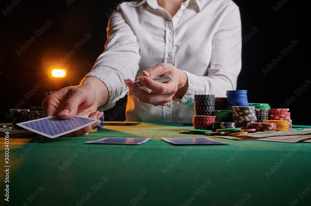 Croupier hands out cards on the background of casino chips Croupier hands out cards on the background of casino chips