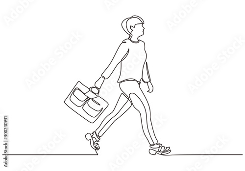 Continuous one line drawing of woman walking on the street. Beauty and fashionable girl holding suitcase.