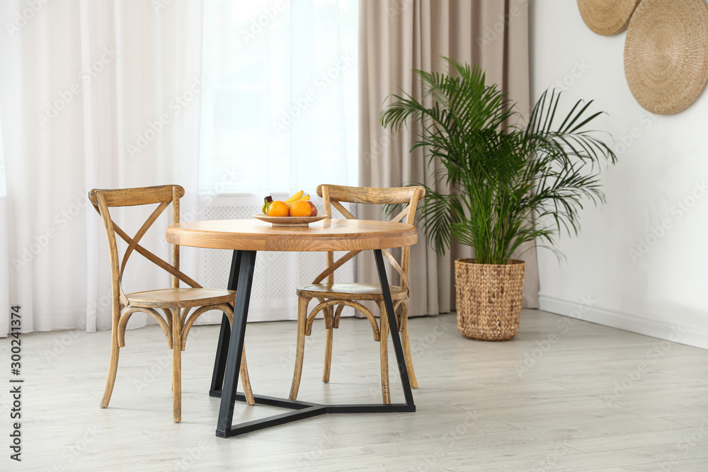 Stylish room interior with dining table and chairs Stylish room interior with dining table and chairs