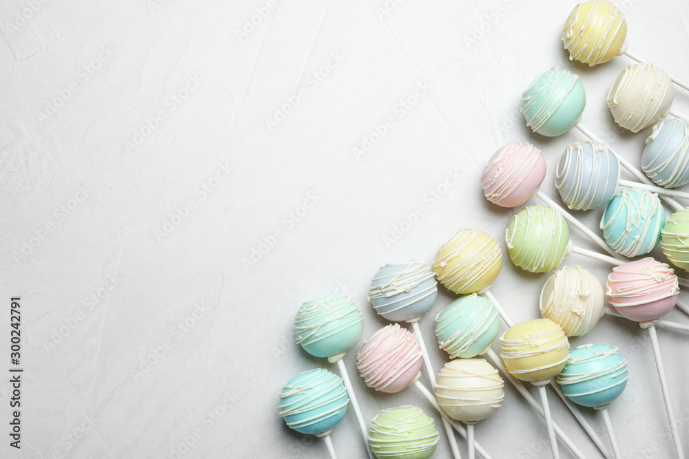 Sweet cake pops on light grey background, flat lay. Space for text Sweet cake pops on light grey background, flat lay. Space for text