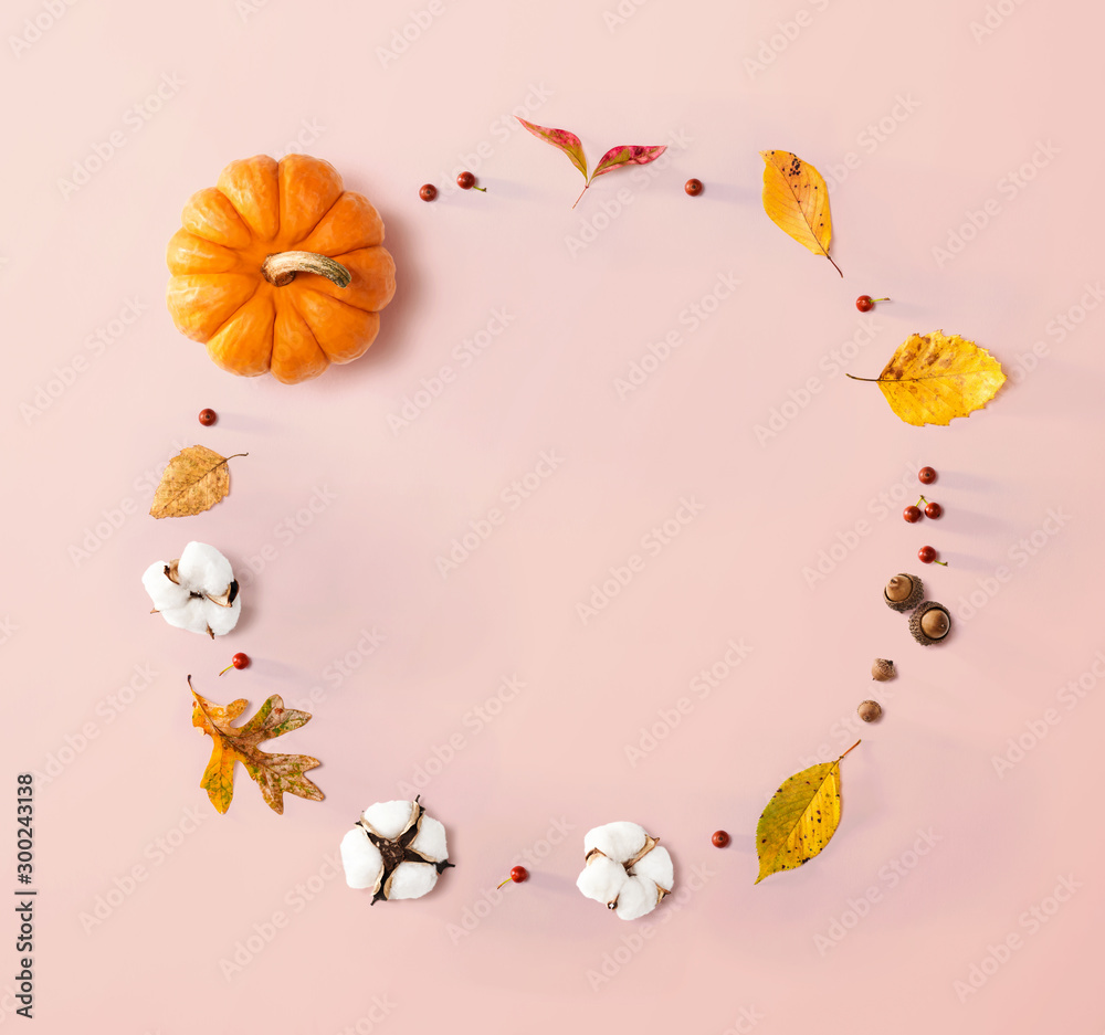 Fototapeta premium Autumn theme with orange pumpkin - flat lay