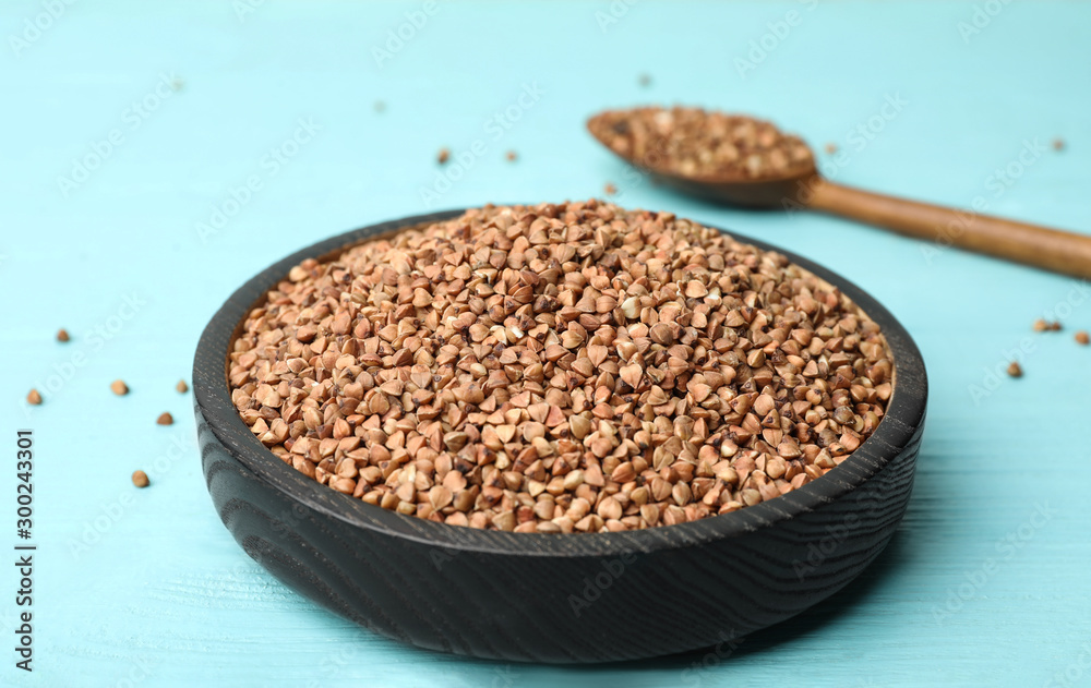 Buckwheat grains on light blue wooden table Buckwheat grains on light blue wooden table