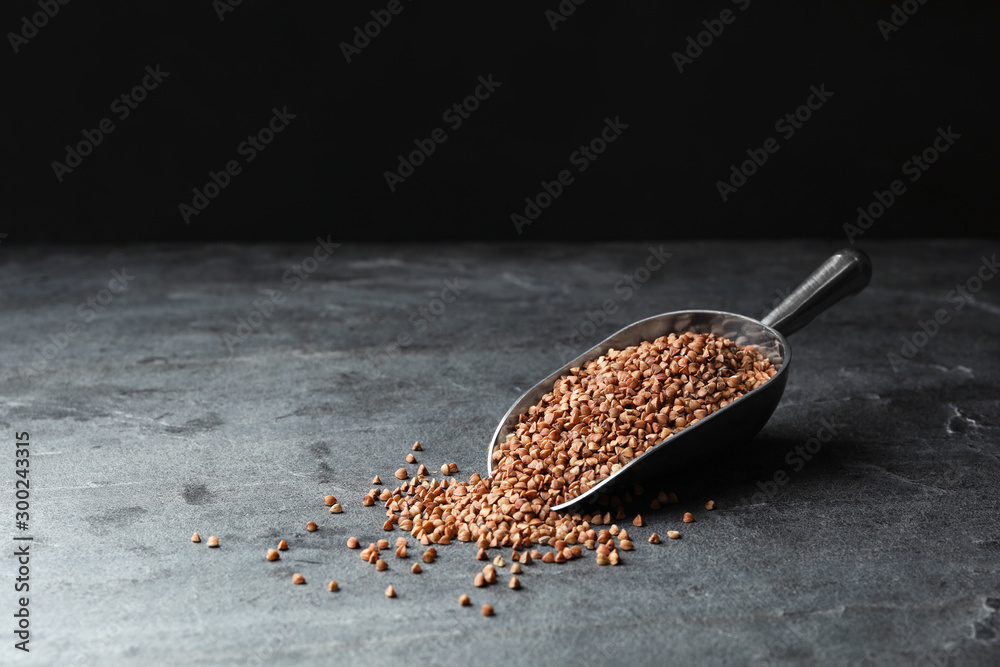 Fototapeta premium Buckwheat grains on grey table. Space for text