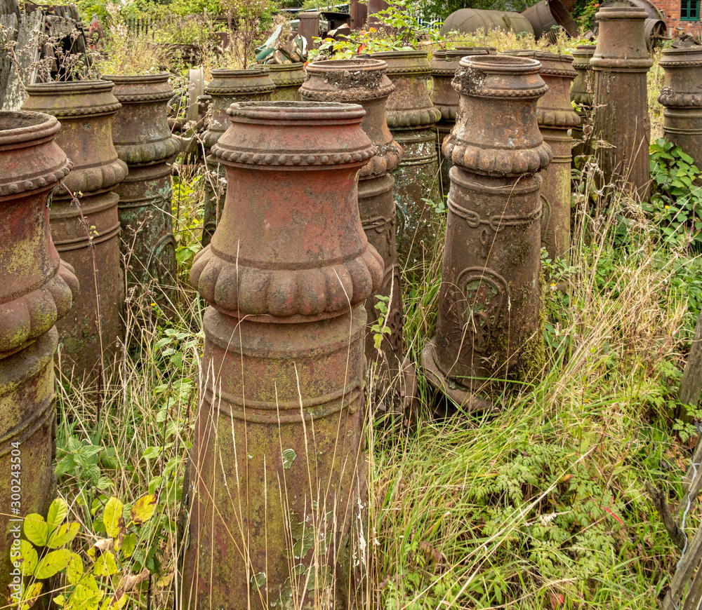Lines of decorative Victorian chimney pots in a grassy yard England UK Lines of decorative Victorian chimney pots in a grassy yard England UK