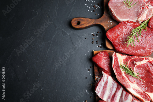 Flat lay composition with fresh meat on grey table. Space for text photo