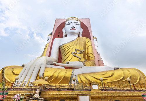Big four giant Buddha statues or  Kyaik Pun pagoda on blue sky at Bago , Myanmar   photo
