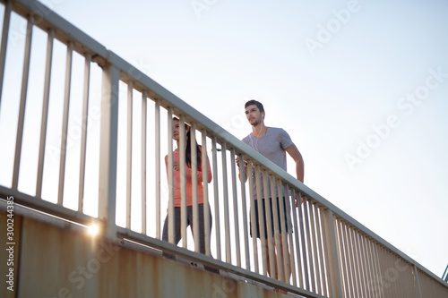 Young couple jogging outdoors on a bridge
