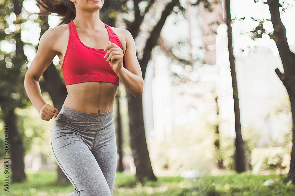 Young fitness woman running around in the park. Young fitness woman running around in the park.