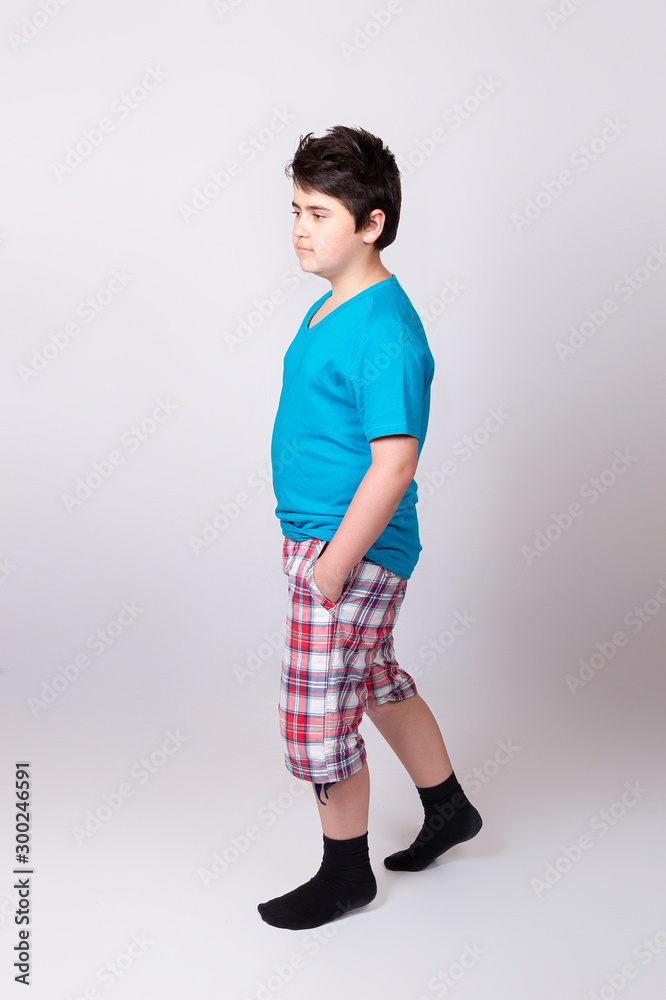 Teen boy on a gray background steps in socks Stock Photo | Adobe Stock