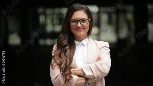 Young Beautiful Business Woman Or Student in Suit On the Street. She Is Smiling, Happy And Looking Into the Camera. Concept: New Business, Communication, Banker, Manager.
