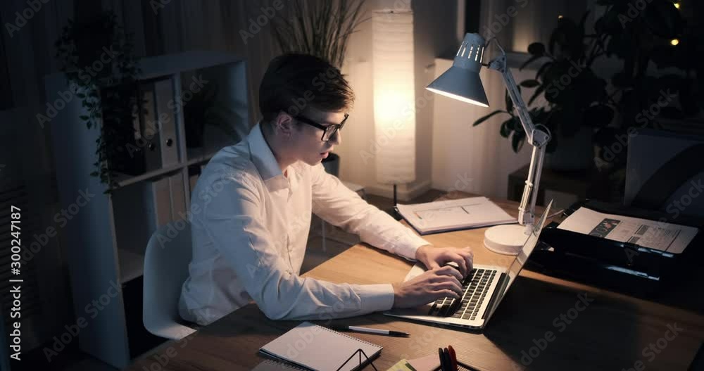 Businessman working on laptop late in the night at office