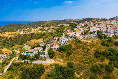 Cyprus. The village of Pissouri. The resort area of ??Pissouri village. Cyprus architecture. Sights of pissouri. Cities of Cyprus. Low-rise buildings. Mediterranean shore. Hillside houses. photo