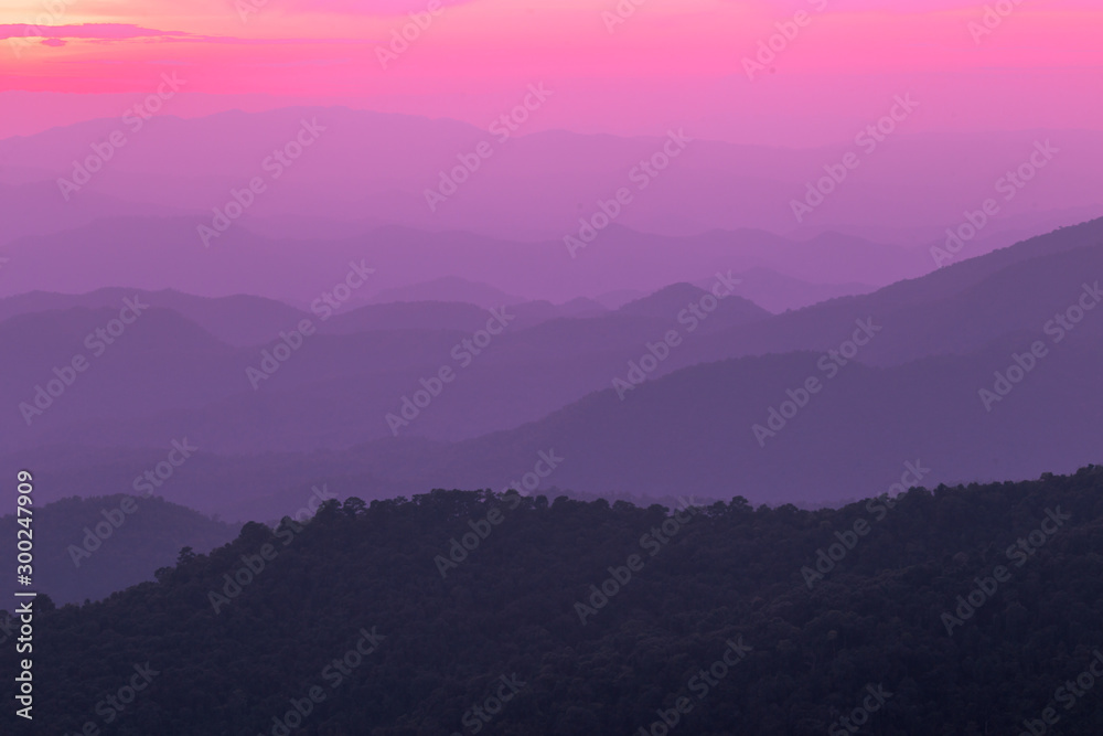 The blurred natural background of colorful twilight in the evening, on the high mountains, with many forests, provide fresh air and preserve the ecology.