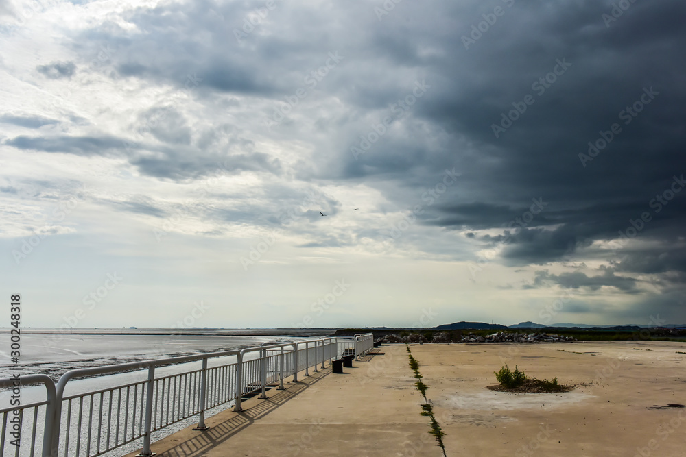 In summer, beautiful coastline and island scenery in cloudy background.