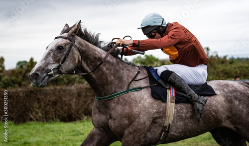 Photos Close up on sprinting race horse and jockey on the race track